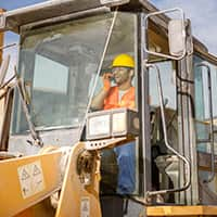 Construction worker operating heavy machinery